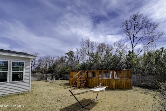 view of yard with a fenced backyard and a deck