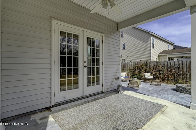 view of patio / terrace with ceiling fan, fence, and french doors