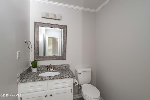 bathroom featuring toilet, baseboards, ornamental molding, and vanity