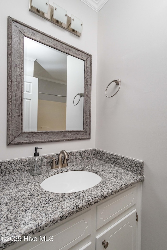 bathroom with crown molding and vanity