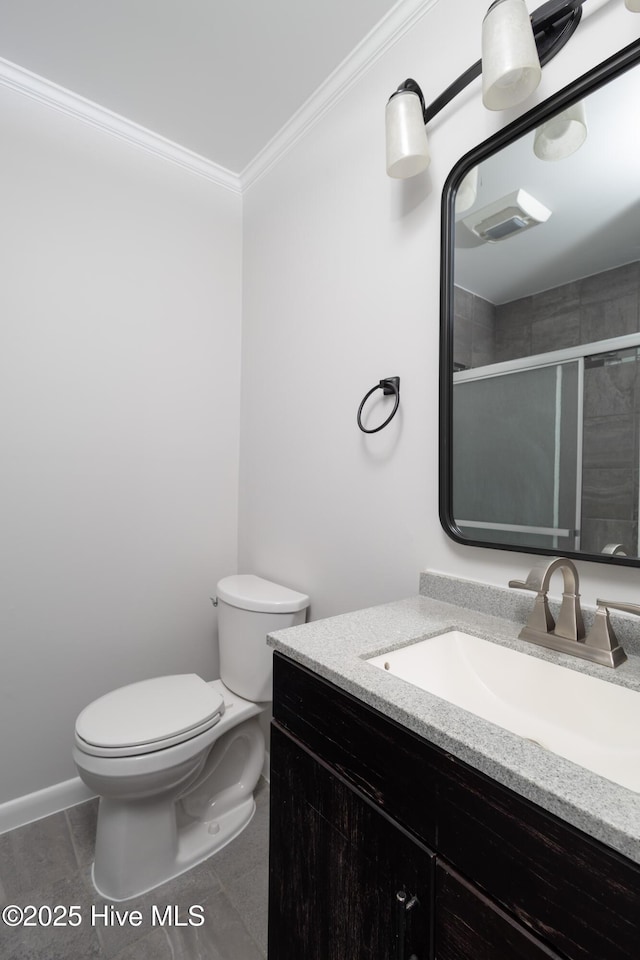 full bathroom featuring toilet, ornamental molding, a stall shower, vanity, and tile patterned floors