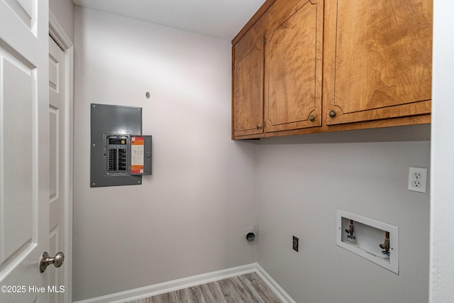 laundry area featuring cabinet space, baseboards, wood finished floors, hookup for an electric dryer, and washer hookup