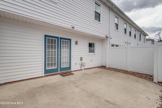 exterior space with fence, french doors, and a patio