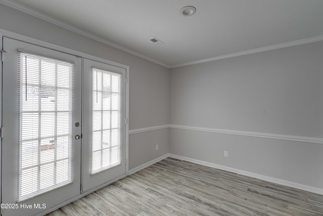 entryway with light wood-type flooring, a wealth of natural light, and french doors