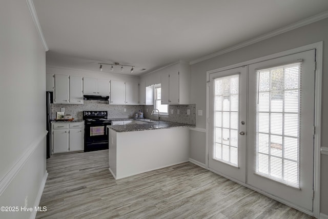 kitchen featuring ornamental molding, a peninsula, french doors, black appliances, and backsplash