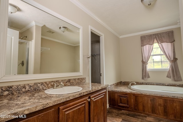 full bath with crown molding, a shower stall, vanity, wood finished floors, and a bath