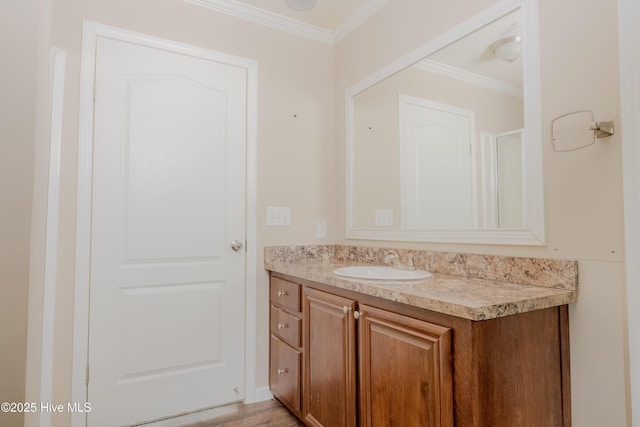 bathroom featuring crown molding and vanity