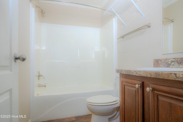 bathroom with toilet, shower / bathtub combination, and vanity