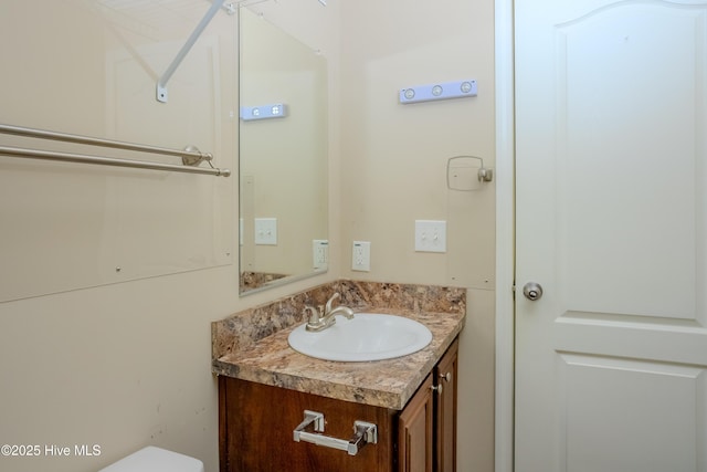 half bath featuring toilet and vanity