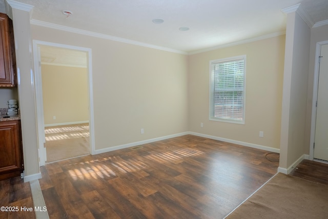 unfurnished room with baseboards, dark wood-style flooring, and ornamental molding