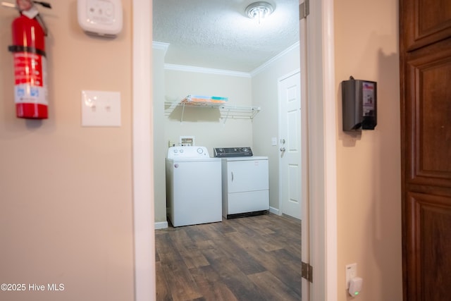 washroom with dark wood-style flooring, crown molding, a textured ceiling, washer and dryer, and laundry area