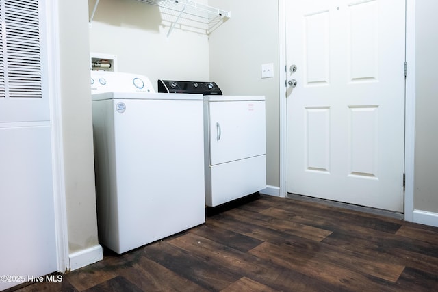 laundry room with laundry area, baseboards, separate washer and dryer, and dark wood finished floors