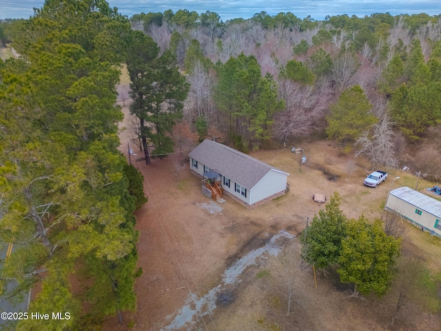 birds eye view of property with a forest view