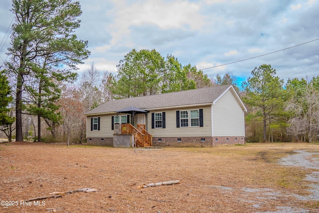 view of front of property with crawl space and roof with shingles