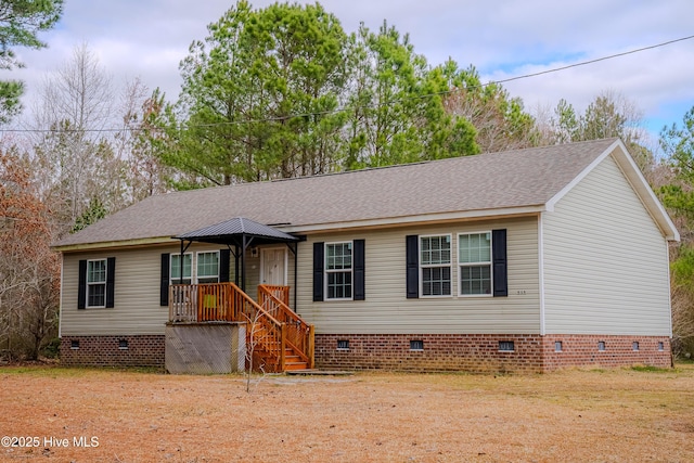 view of front of property with a shingled roof and crawl space