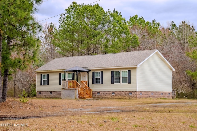 view of front facade with roof with shingles and crawl space