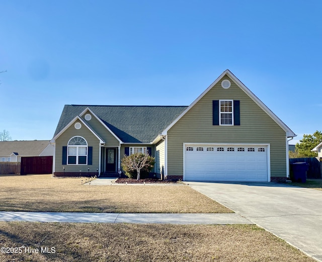 view of front facade with driveway and fence