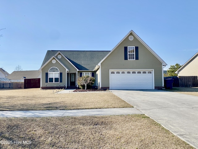 view of front of house featuring driveway and fence