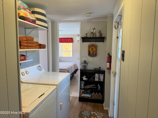 clothes washing area featuring laundry area, dark wood-style flooring, and independent washer and dryer