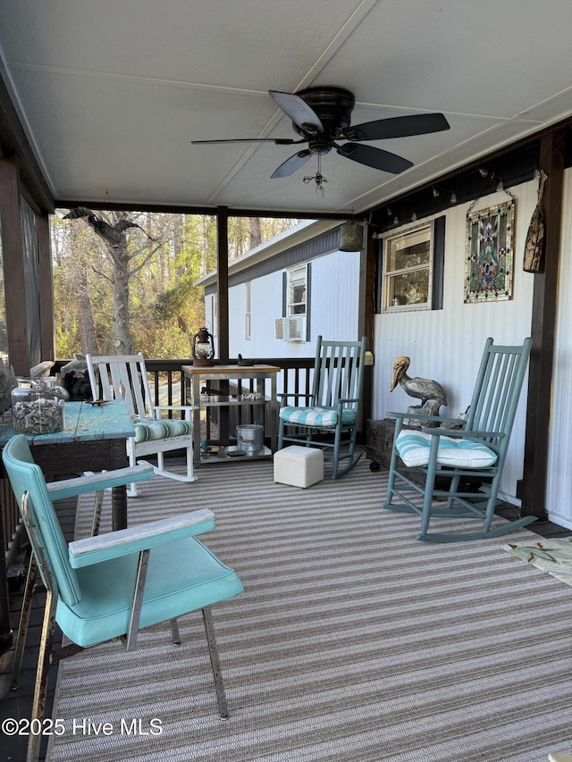 wooden terrace featuring a ceiling fan