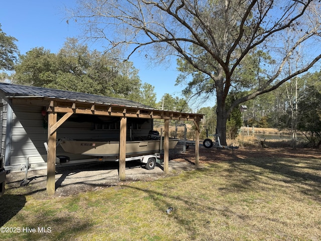 view of yard featuring a detached carport, a pole building, and an outdoor structure