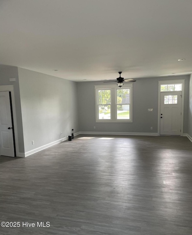 305 Pine Knoll Cir, Pine Knoll Shores, NC 28512 - unfurnished living room featuring dark wood-style flooring, baseboards, and ceiling fan