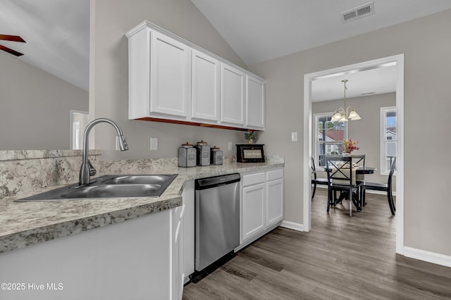 kitchen with visible vents, stainless steel dishwasher, white cabinetry, vaulted ceiling, and a sink