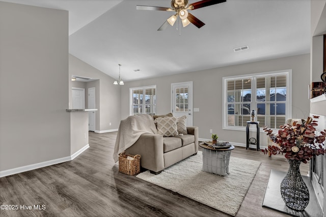 living room featuring ceiling fan, wood finished floors, visible vents, baseboards, and vaulted ceiling