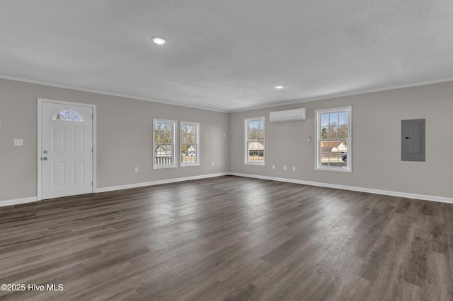 unfurnished living room with dark wood-style flooring, baseboards, an AC wall unit, electric panel, and crown molding