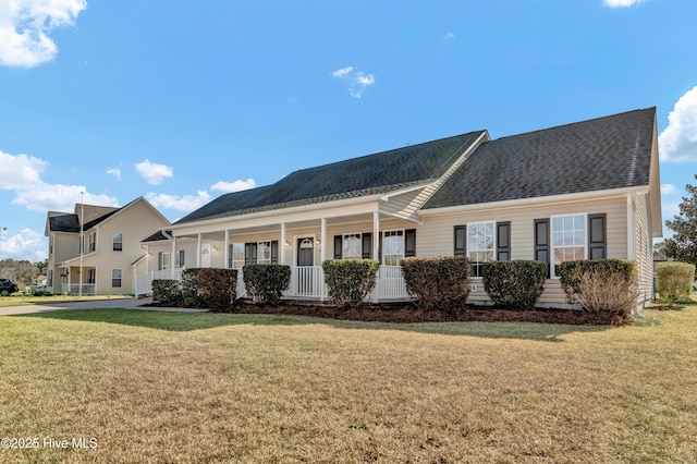 ranch-style house with covered porch, a front lawn, and roof with shingles