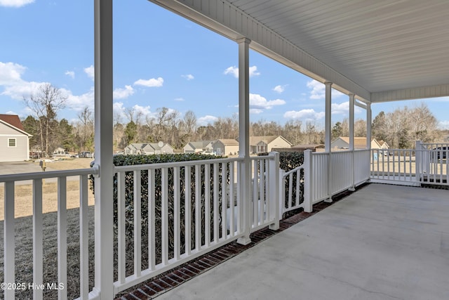 balcony featuring covered porch and a residential view