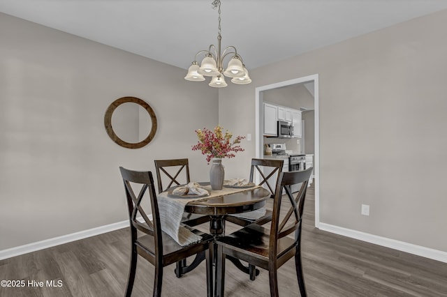 dining space with dark wood-style floors, baseboards, and an inviting chandelier