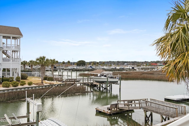 dock area with boat lift and a water view