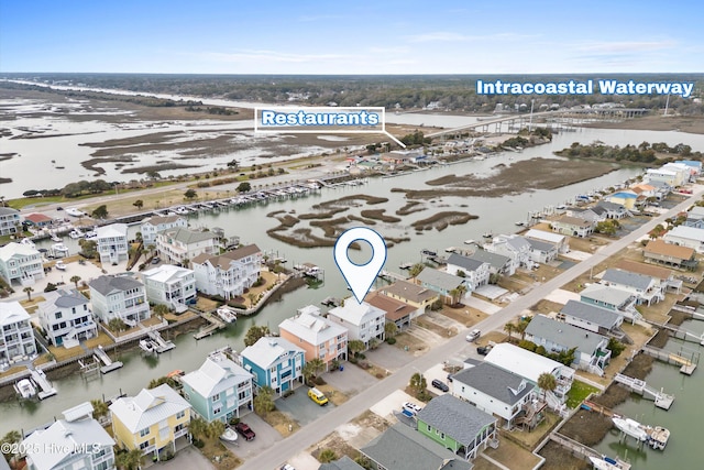 drone / aerial view with a residential view and a water view