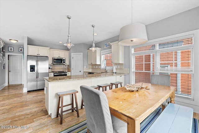 dining area featuring light wood finished floors