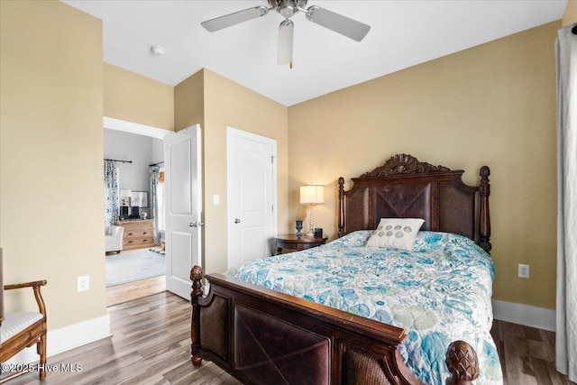 bedroom with ceiling fan, baseboards, and wood finished floors