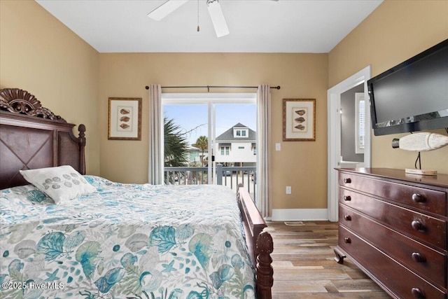 bedroom featuring access to outside, ceiling fan, baseboards, and wood finished floors