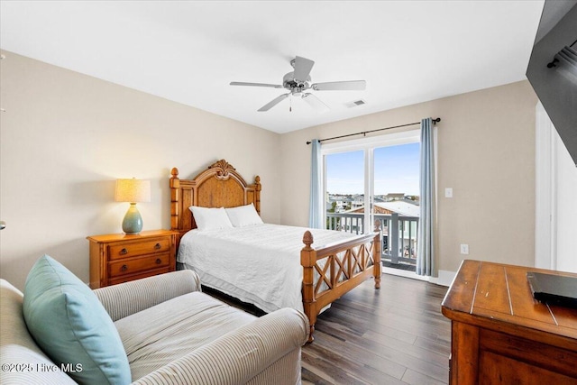 bedroom with visible vents, a ceiling fan, wood finished floors, baseboards, and access to exterior