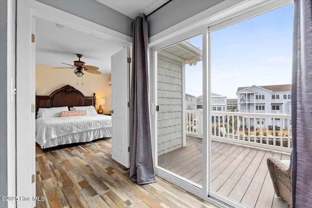 bedroom with a residential view and wood-type flooring