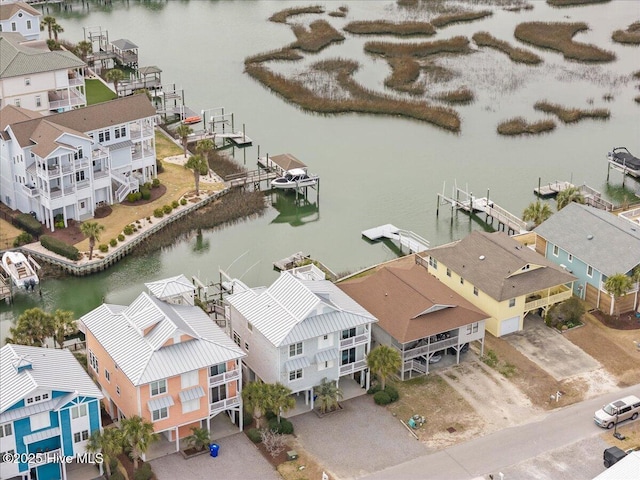 birds eye view of property featuring a water view and a residential view