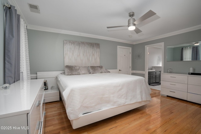 bedroom featuring ornamental molding, ceiling fan, light wood-style flooring, and visible vents