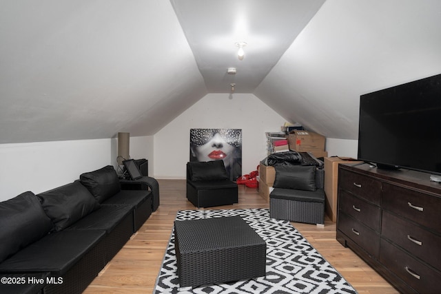 living room featuring vaulted ceiling and light wood-style floors