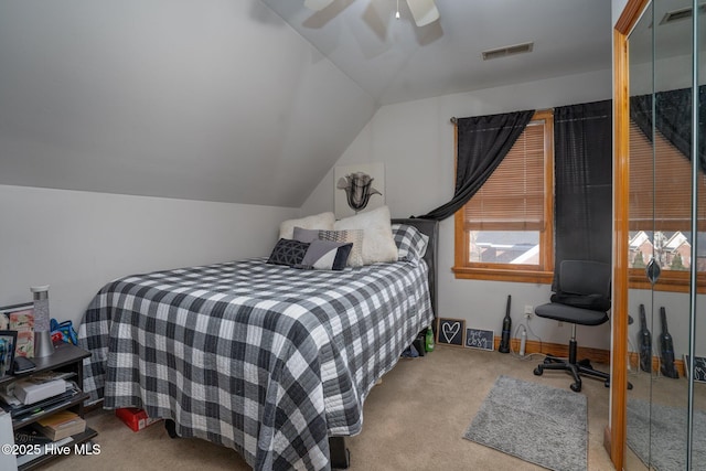 bedroom featuring a ceiling fan, lofted ceiling, visible vents, and carpet