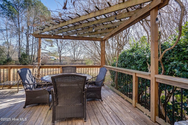 deck with outdoor dining space and a pergola