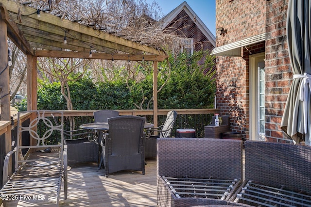 deck featuring outdoor dining area and a pergola