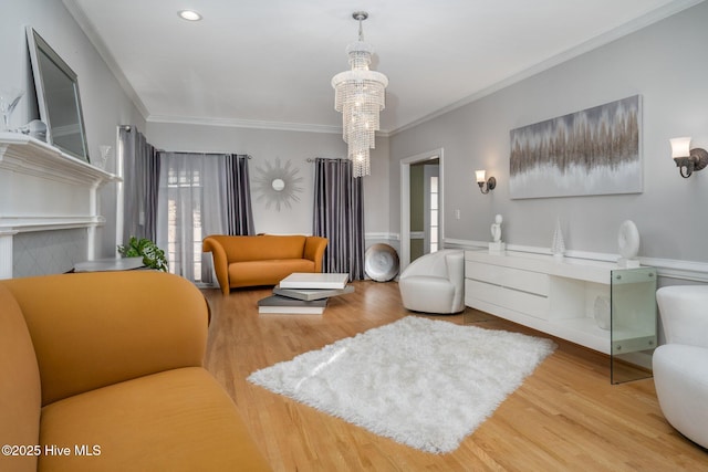 living room featuring ornamental molding, a chandelier, wood finished floors, and recessed lighting