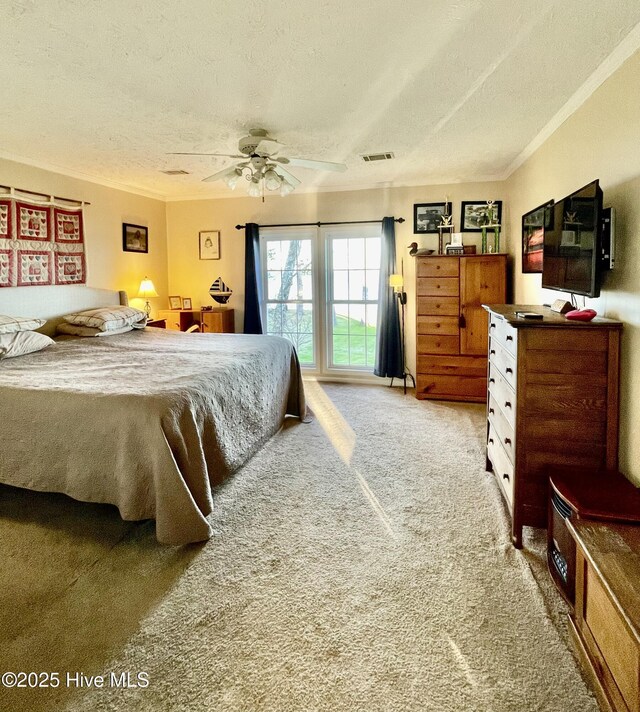 hallway with baseboards, visible vents, light tile patterned flooring, a textured ceiling, and crown molding