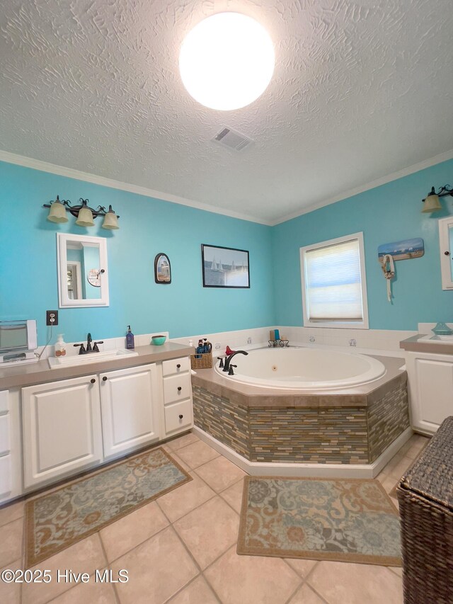 laundry room featuring visible vents, crown molding, washing machine and dryer, laundry area, and a textured ceiling