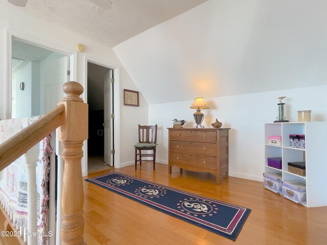 bathroom with lofted ceiling, vanity, and tile patterned flooring