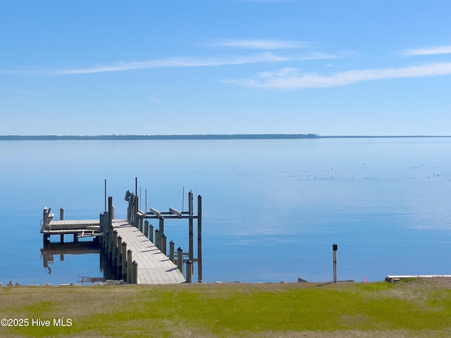 dock area with a water view and boat lift